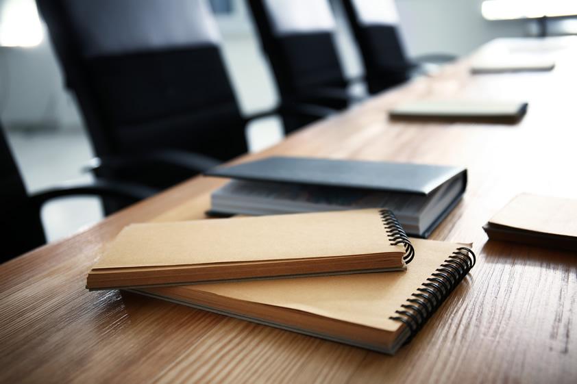 Notebooks on boardroom table